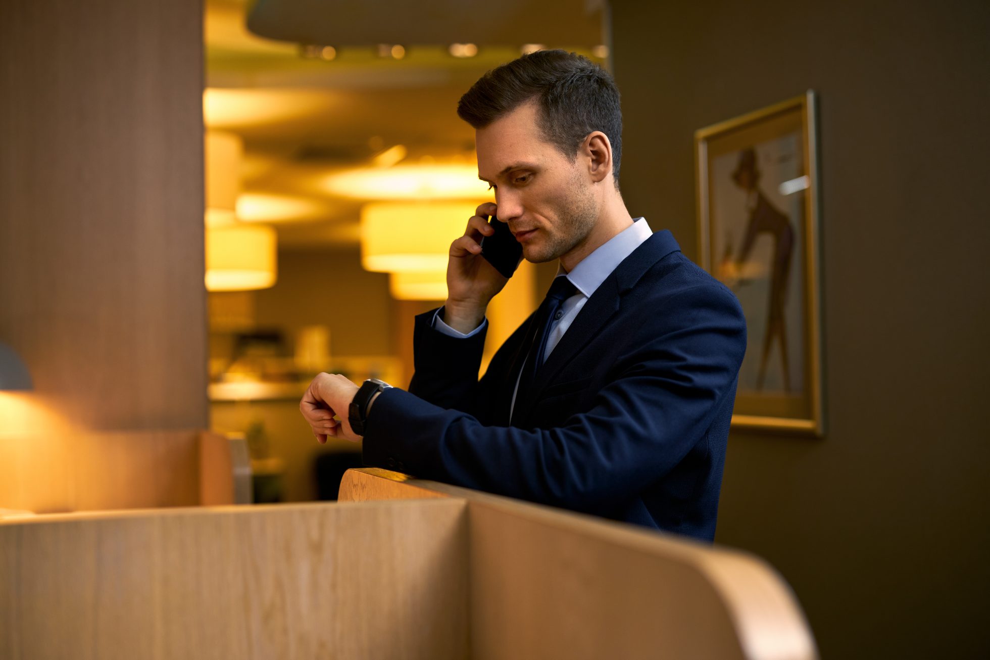 Businessman checking the time on his wrist watch.